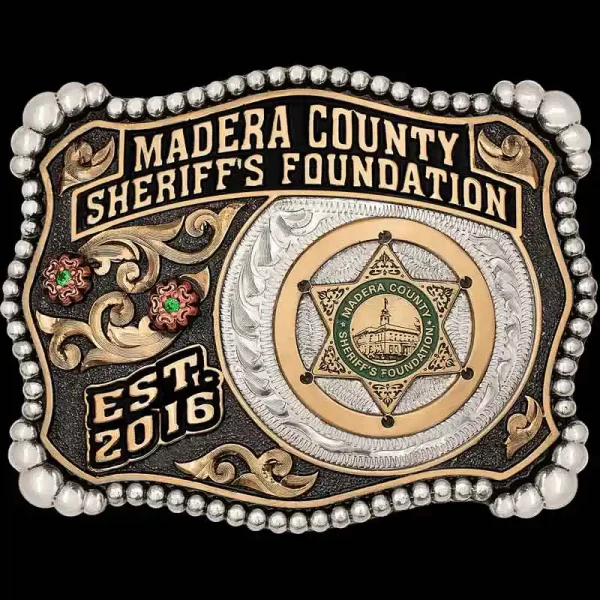 "Our Madera Belt Buckle is a true-blue Western Buckle. The Madera is crafted on a German Silver base with a beaded edge. The gorgeous accents such as the Jeweler's Bronze scrolls, Copper flowers, and enamel banners add color & character to this b